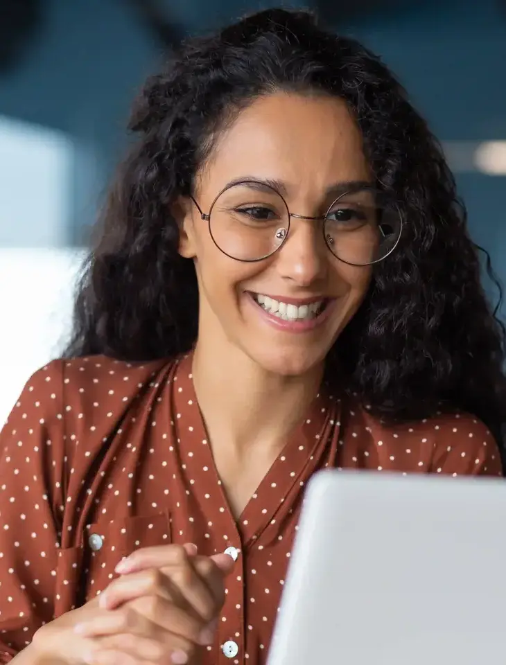 Woman looking at laptop.