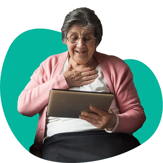 Elderly woman happily connecting with family online using tablet.