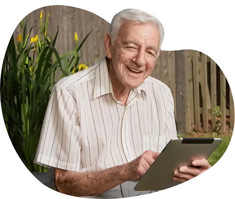 Smiling older man learning on tablet.