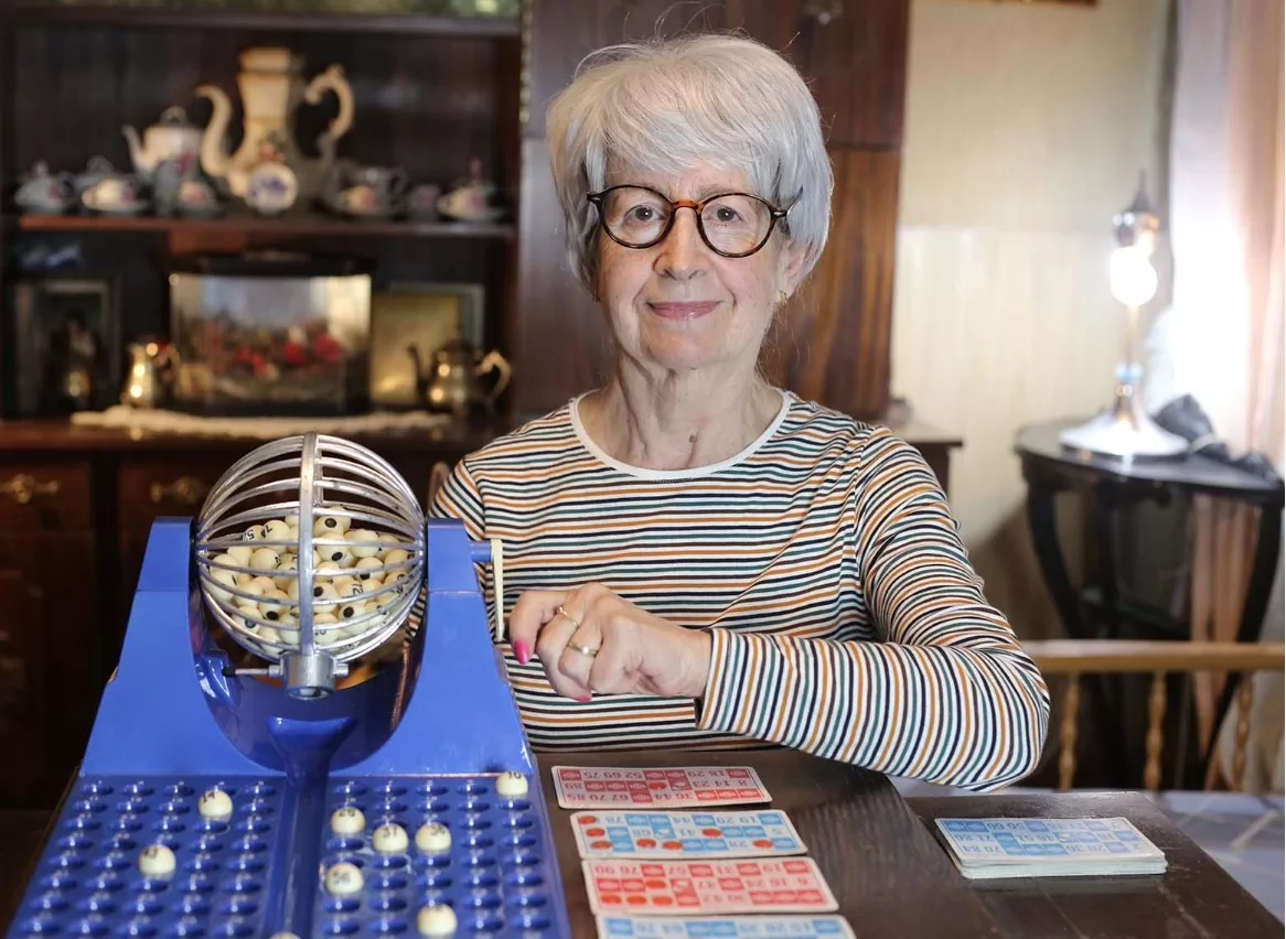 Senior woman enjoying bingo with new programs from Inclusee.
